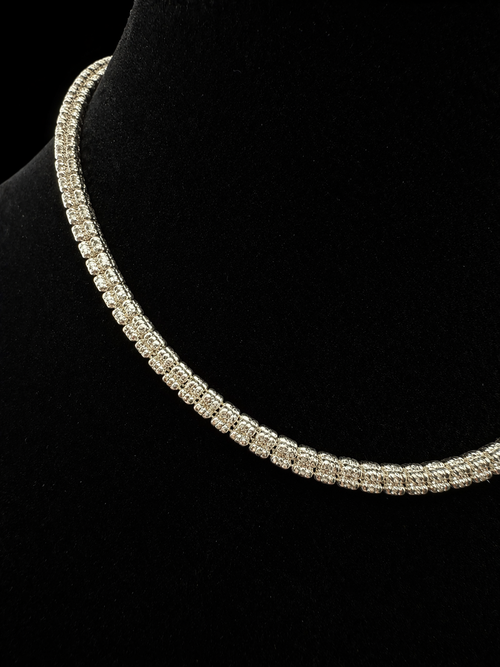 Silver necklace on a black velvet stand