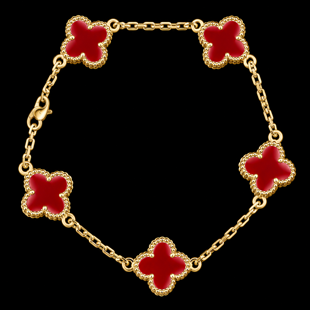 A gold chain bracelet featuring five red enameled four-leaf clover motifs with beaded gold borders, displayed against a solid black background.