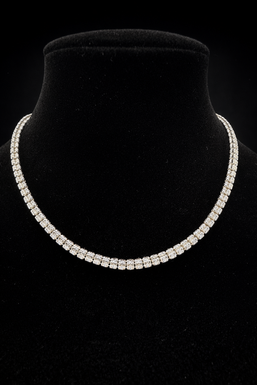 Diamond necklace on a black velvet stand against a black background