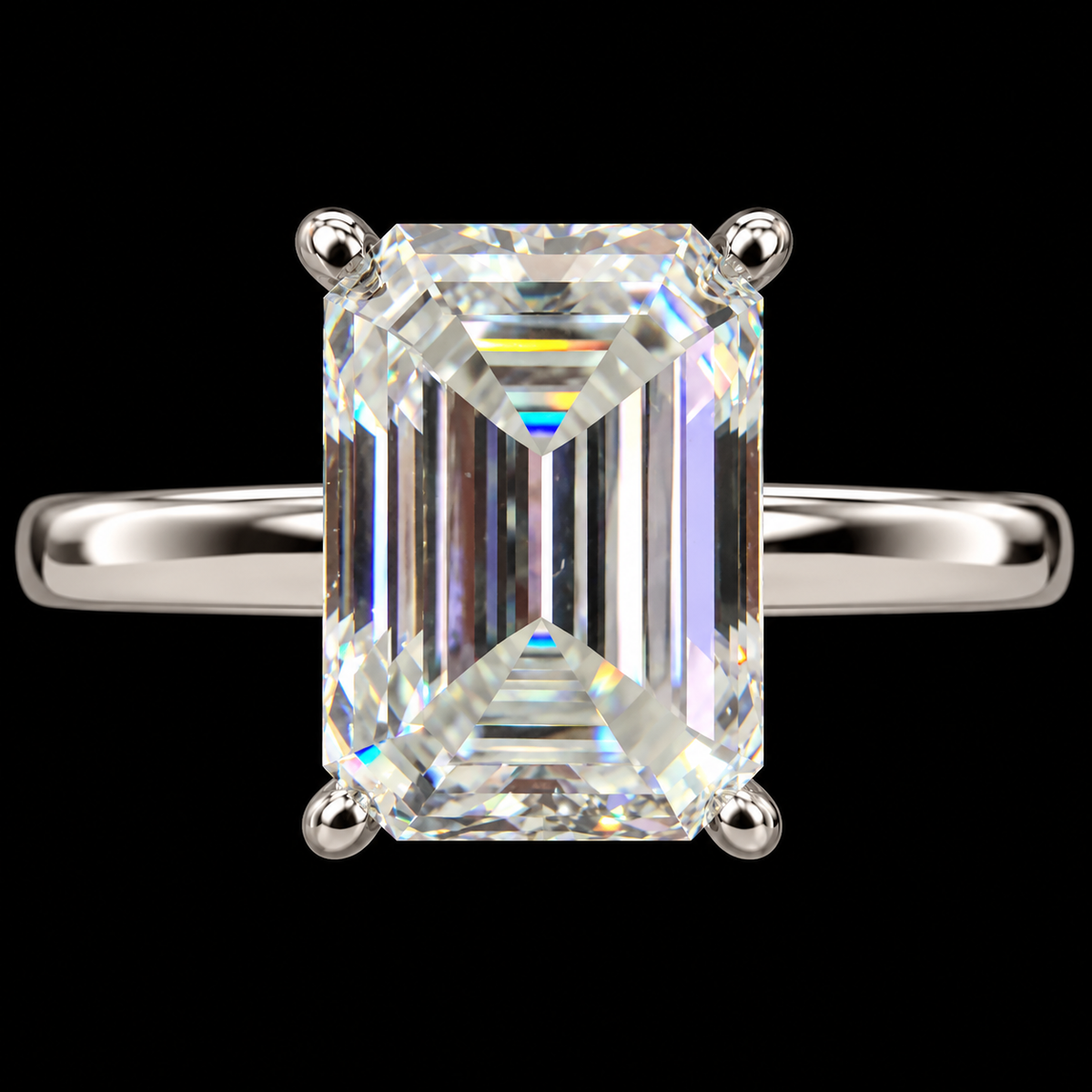 An emerald-cut diamond ring with a silver-colored band, set against a solid black background.