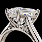 Close-up of a solitaire engagement ring featuring a large emerald-cut diamond set in a polished silver-colored metal band, shown against a solid black background.