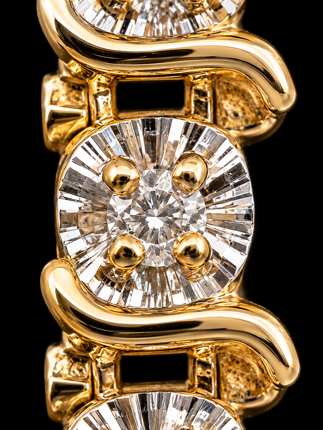 Close-up of a yellow gold bracelet featuring cushion-cut diamonds with four round diamonds set in each link, photographed against a solid black background.